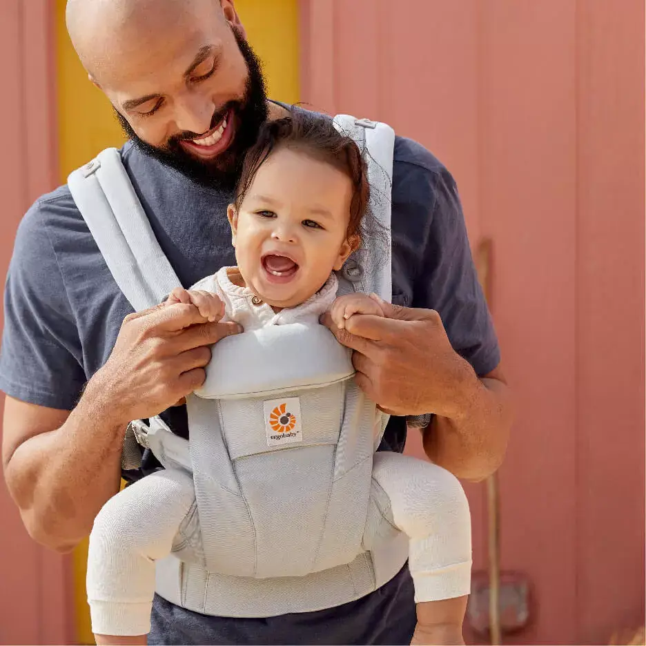 mother carrying child in baby carrier Omni dream